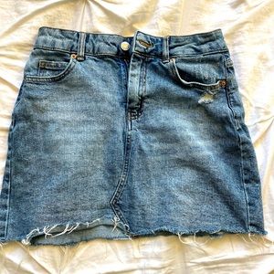 Blue distressed denim mini skirt